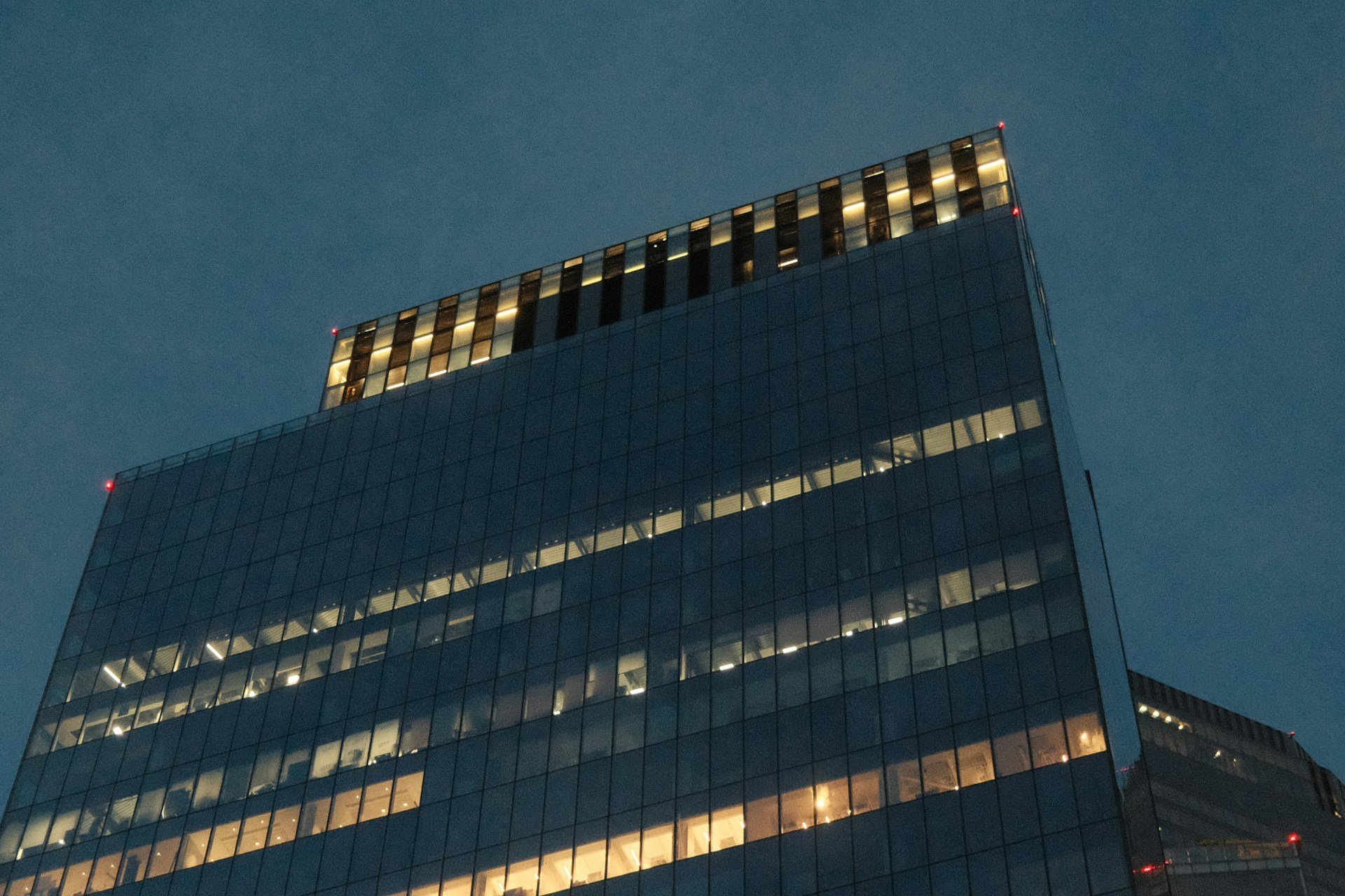 Modern glass architecture illuminated at dusk